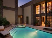 Night View of Illuminated Private Pool With Loungers and View Into Presidential Suite 