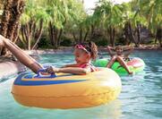 Two Kids on Inflatables in River Pool