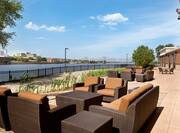 Outdoor Patio Seating Area with Armchairs, Sofa and Coffee Table with City Skyline Background