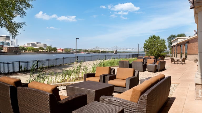 Outdoor Patio Seating Area with Armchairs, Sofa and Coffee Table with City Skyline Background