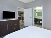 Suite Bedroom with Queen Bed and TV