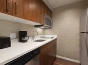 In-Suite Kitchen with toaster, coffee maker, and fridge