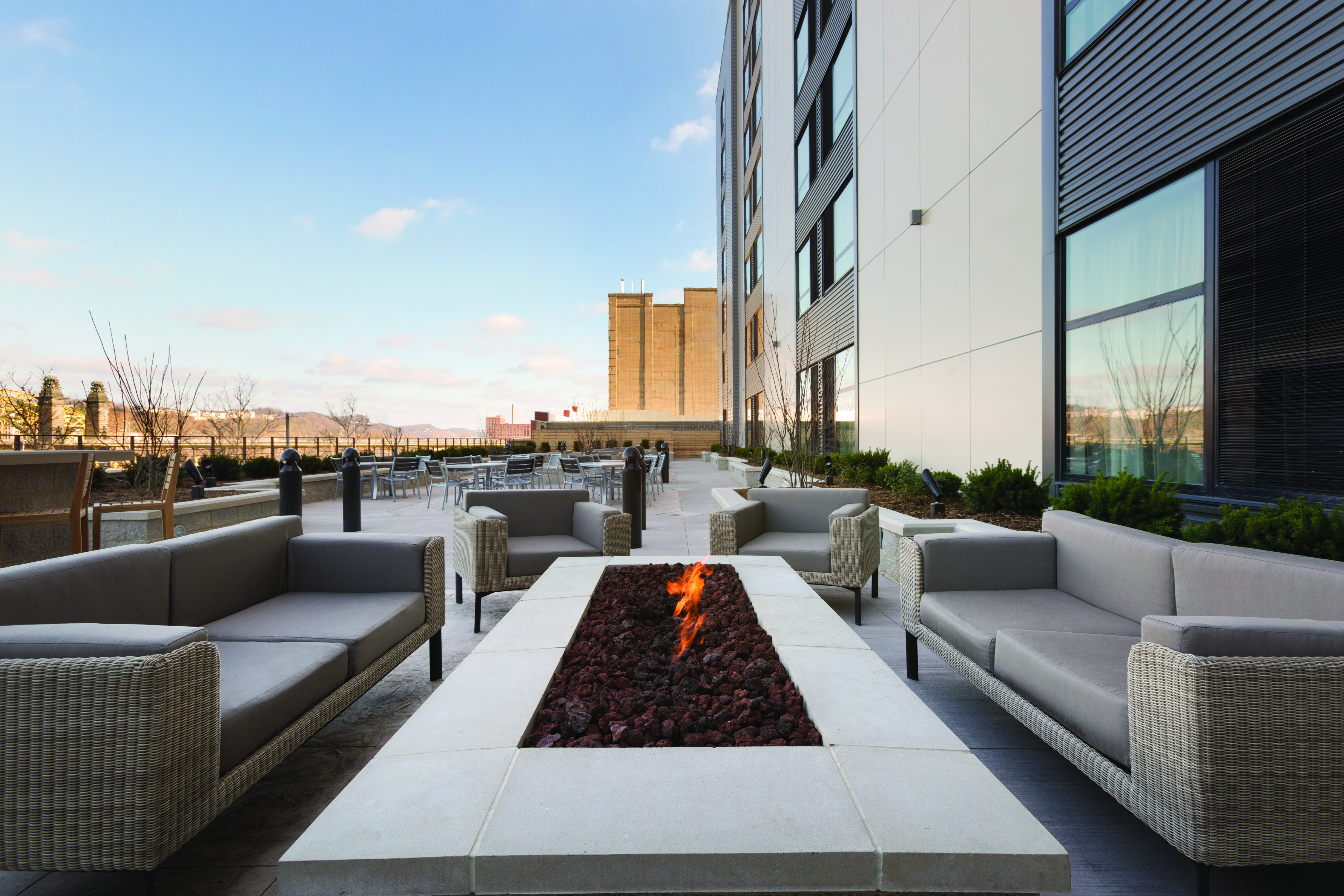Outdoor Seating area with lounge sofas and chairs surrounding fire pit