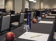 Meeting Room Classroom Setup Close-Up of Table, Apple, Paper, Pen and Glass