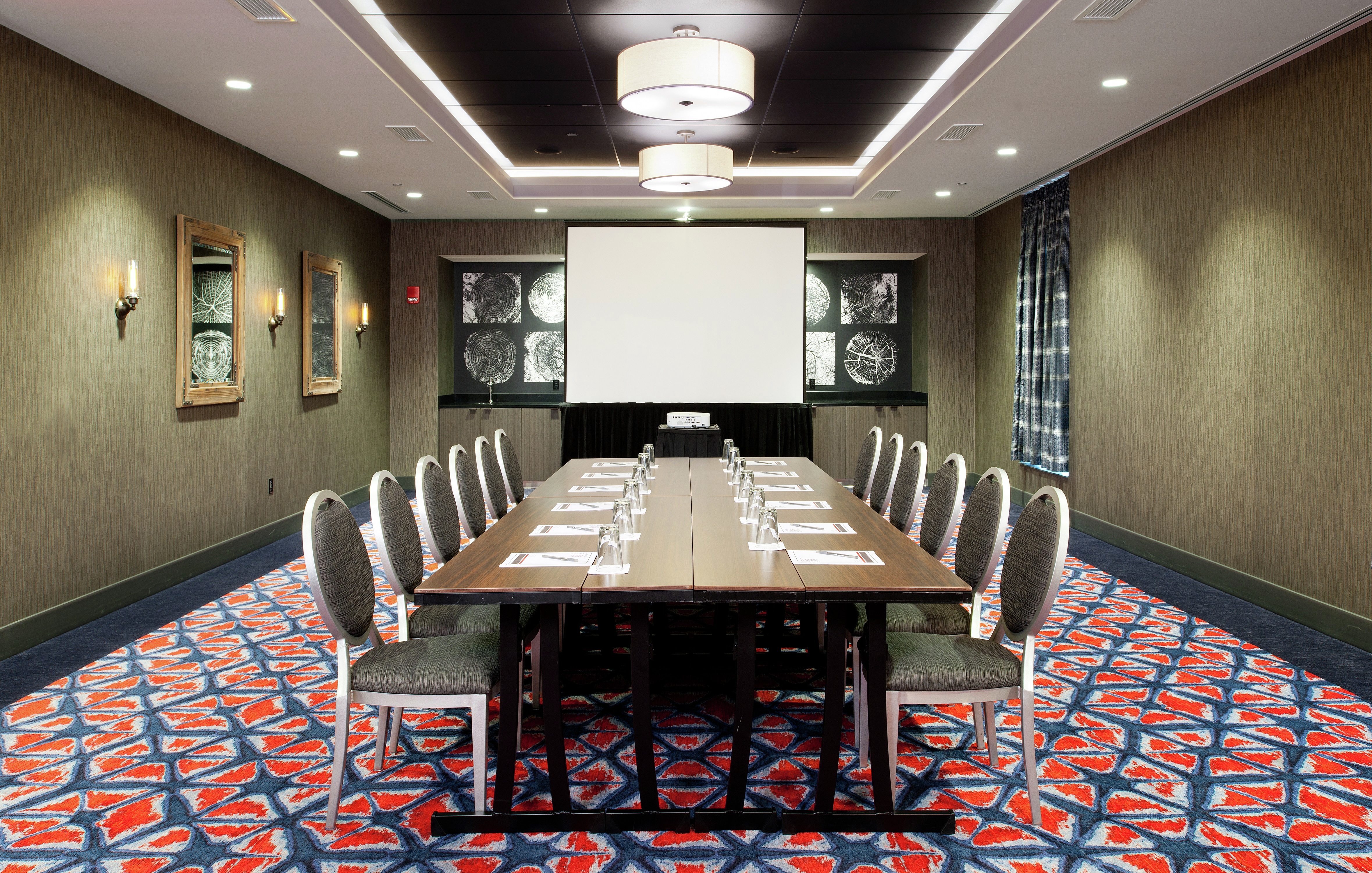 Seating for 12 at Large in Meeting Room With Presentation Screen and Wall Art