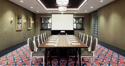 Seating for 12 at Large in Meeting Room With Presentation Screen and Wall Art