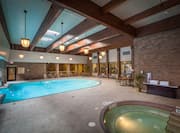 Windows, Tables, Chairs, and Towel Station by Indoor Swimming Pool and Hot Tub