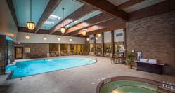 Windows, Tables, Chairs, and Towel Station by Indoor Swimming Pool and Hot Tub