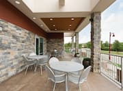 Outdoor Patio With Chairs Around Round Tables