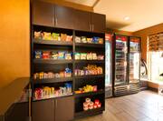 Snack shop suite with snacks, beverages, frozen food selections, and window with outdoor view