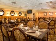 Maxwell's restaurant with dining tables, chairs, dining amenities, and TV
