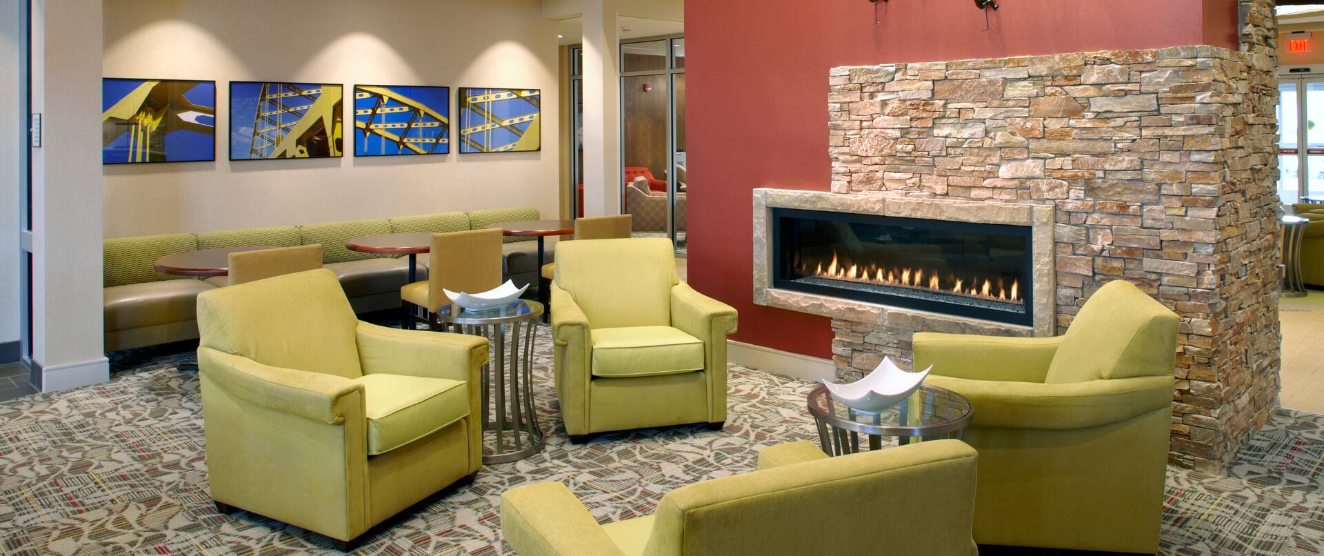 Lobby seating area with fireplace and art on the wall