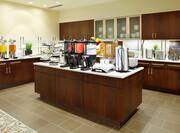 Breakfast serving area with coffee, juice, snacks, and dining amenities