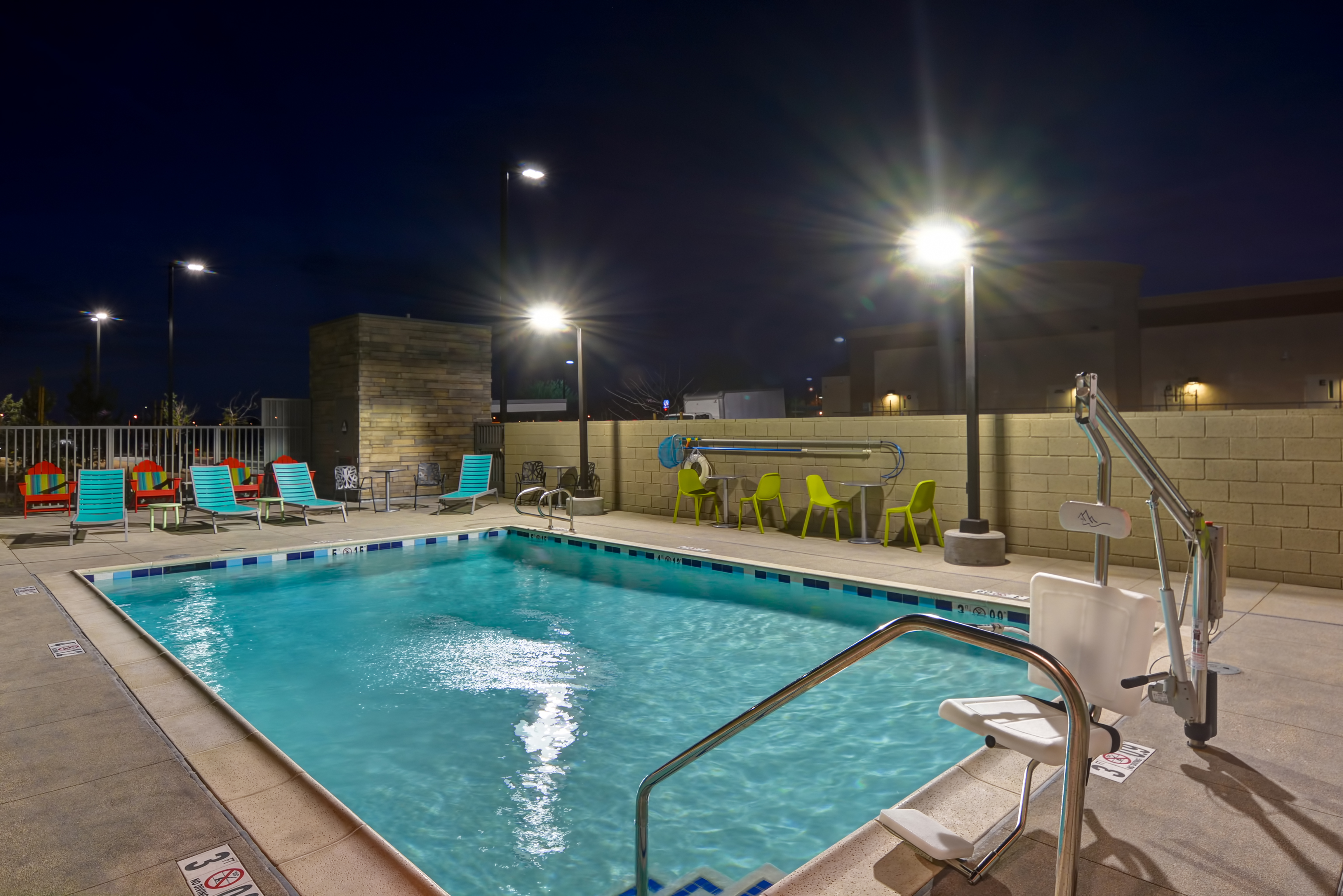 Outdoor Pool and Lounge Chairs at Night