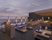 Dusk View of Loungers, Candles, and Soft Seating on Rooftop Lounge at Level 12 Restaurant