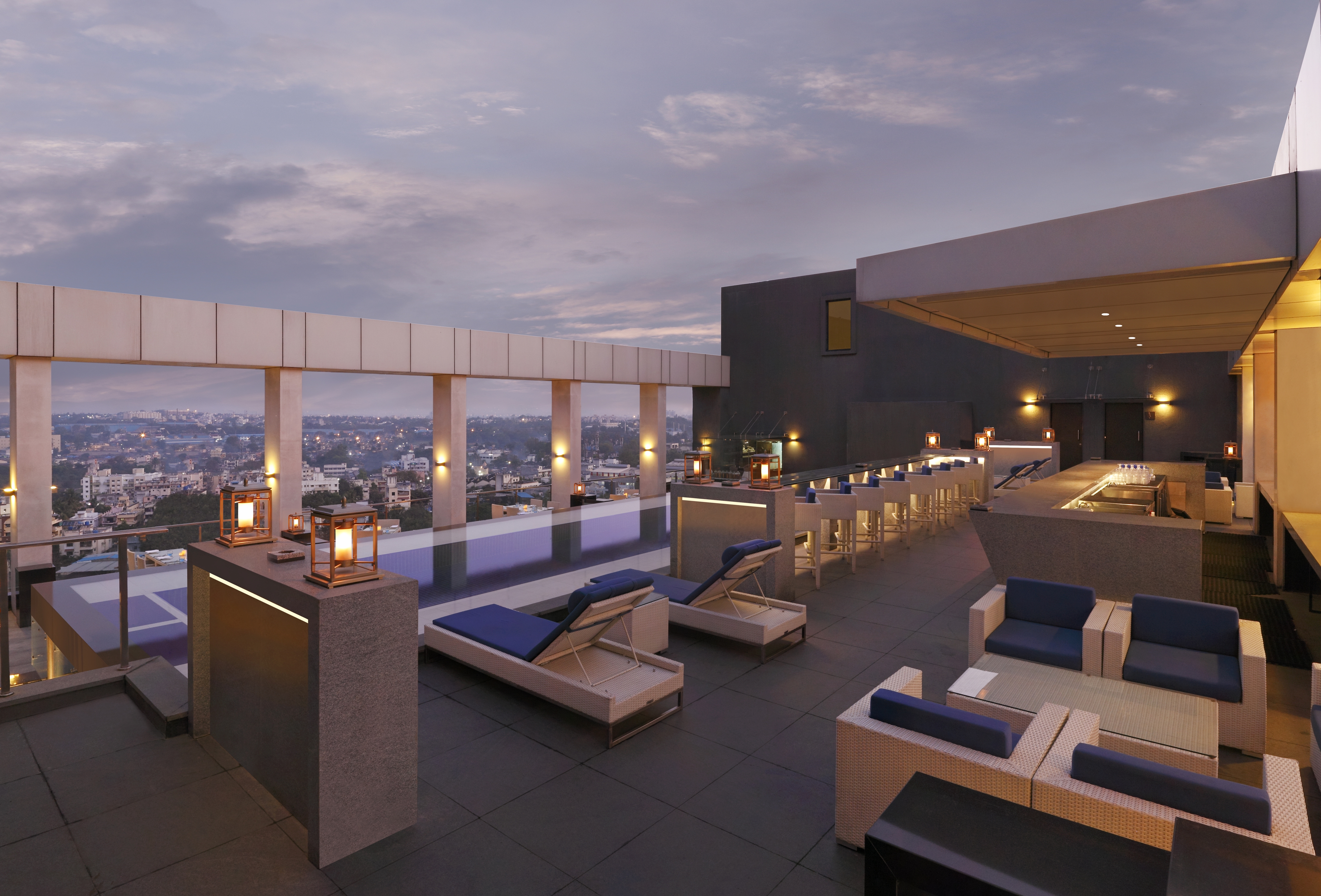 Dusk View of Loungers, Candles, and Soft Seating on Rooftop Lounge at Level 12 Restaurant