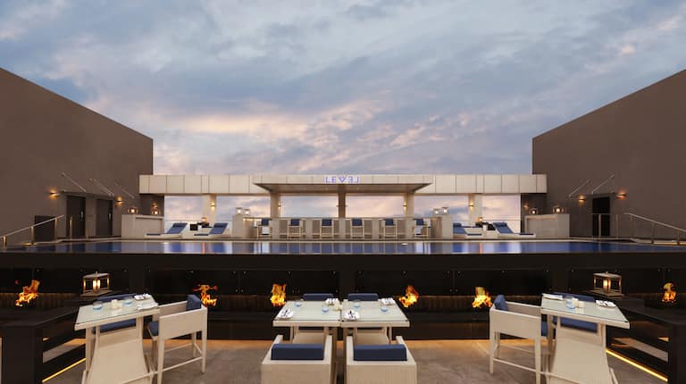 Sunset View of Rooftop Restaurant Seating With Candles at Level Twelve
