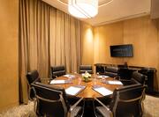Lilac Meeting Room with Round Table Showing Seating for 7 Guests 