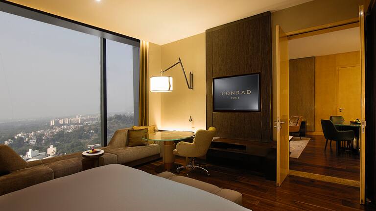 Suite with Desk HDTV and Large Window Offering City Views