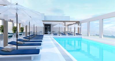 Outdoor pool area with sun loungers