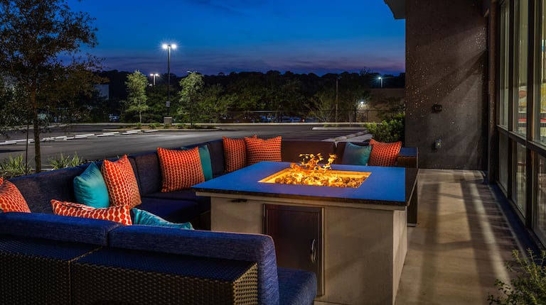 Outdoor Patio with Sitting Area around a Fire Pit at Night