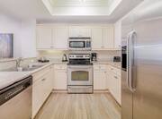 Suite kitchen with fridge, dish washer, sink, oven, stove, microwave, and coffee maker