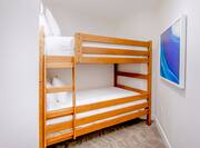Junior suite with two queen bunk beds and art on the wall