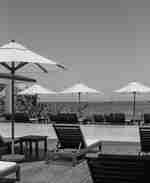 Piscină în aer liber cu șezlonguri și parasoli