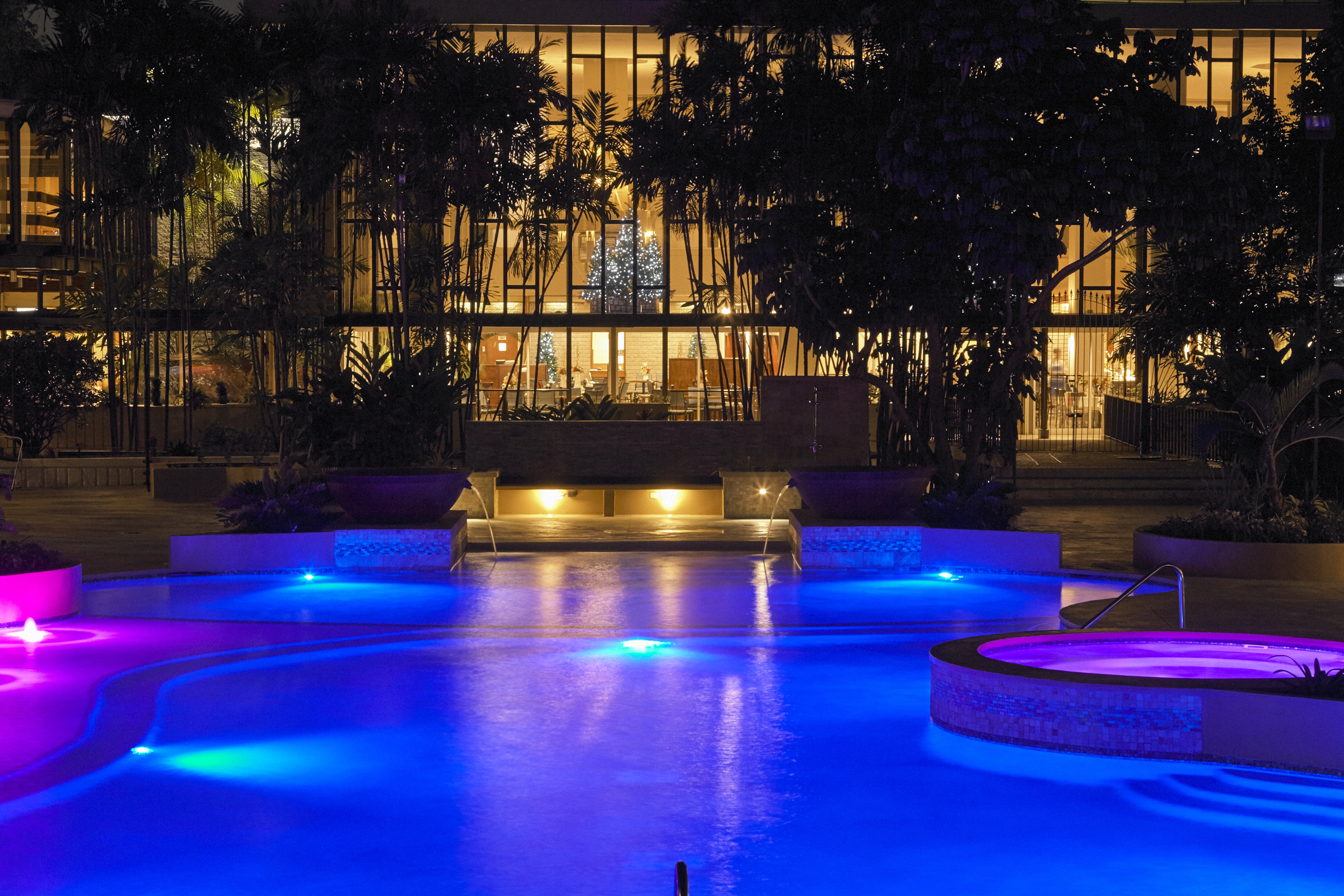 Outdoor Swimming Pool with Sofa at Night
