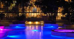Outdoor Swimming Pool with Sofa at Night