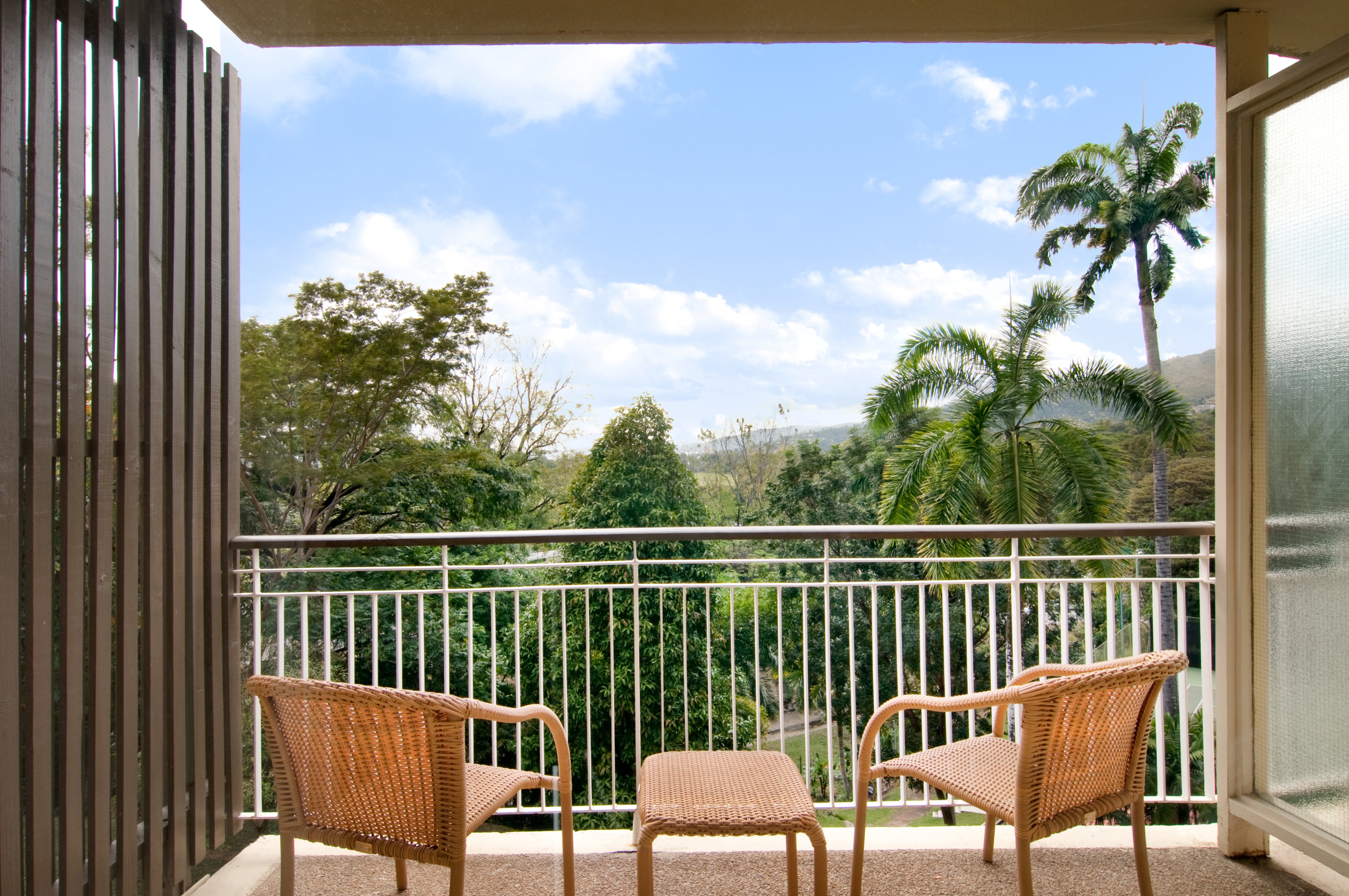 Hotel Room Balcony with Table and 2 Chairs with Garden View