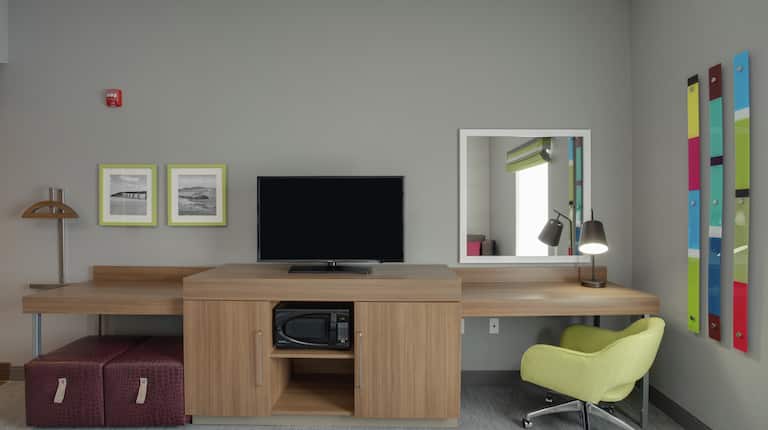 Flat Screen TV, Work Desk with Chair, and Microwave in Guest Room