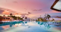 Outdoor Pool Area with Palm Trees at Sunset