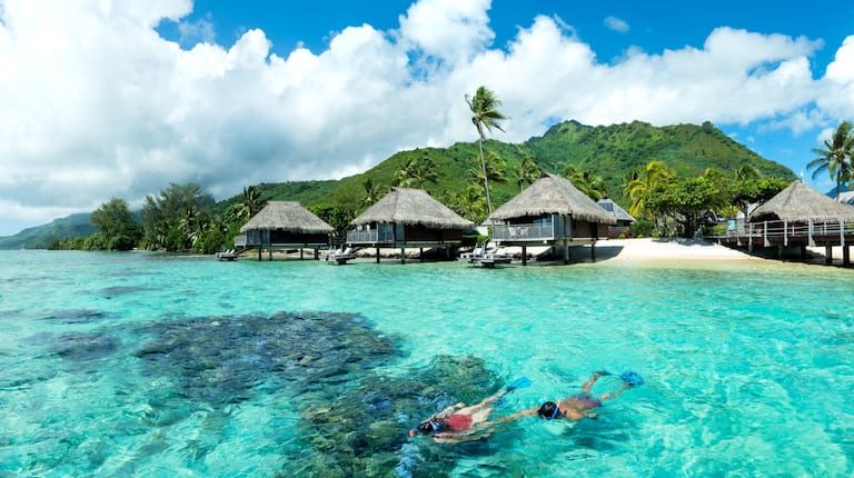 Guests Swimming in Lagoon with View of  Bungalows 