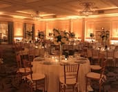 Ballroom with Formal Table Arrangements and Elegant Lighting and Architectural Details 