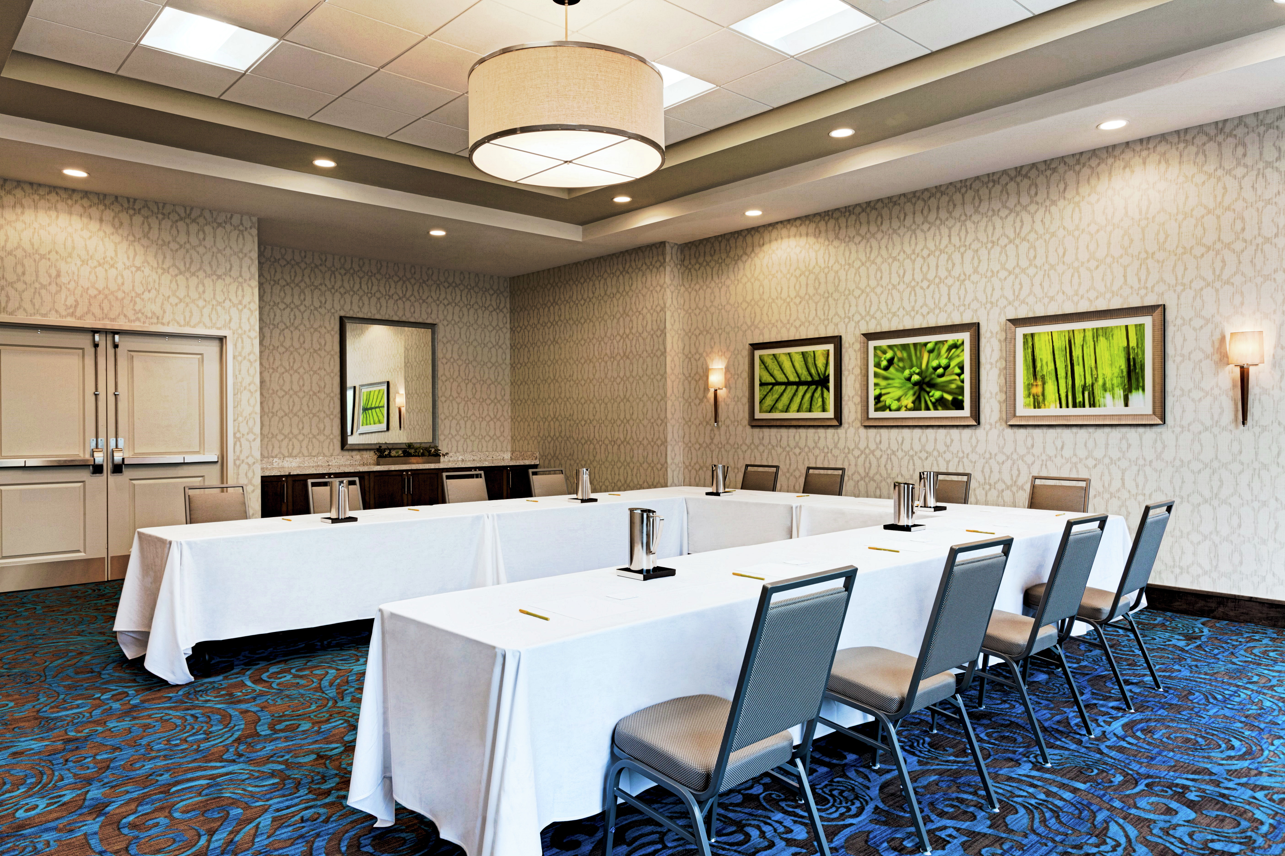 Hotel Meeting Room With U-Shaped Table and Chairs