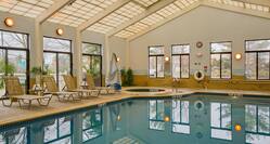 Indoor Pool and Hot Tub with Lounge Chairs on Deck