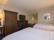 Guestroom with Two Queen Beds, Television, Mini Fridge, Microwave and Entrance