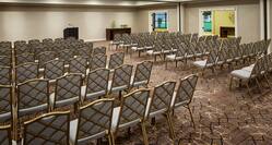 Meeting Space Arranged Theater Style With Rows of Chairs Facing Podium