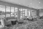 Pre-function area with seating and floor-to-ceiling windows.