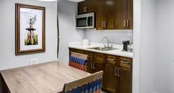 Kitchen with sink, microwave, coffee maker, and dining table
