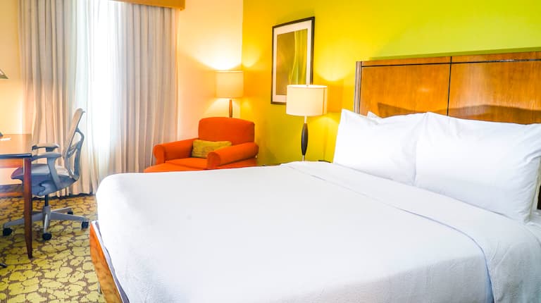 Guestroom with bed and seating area