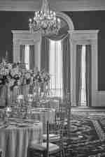 Taneční sál s velkým lustrem a prostorným stolem