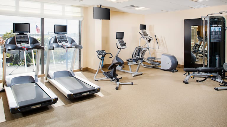 Fitness Center With Cardio Equipment, TV, and Weight Machine