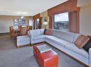 Large couch in suite with dining area