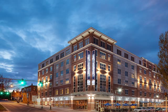 Hotel exterior with signage and road in foreground