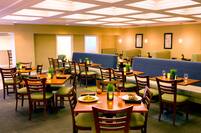 Tables, Chairs, and Booth Seating in Restaurant Dining Area 
