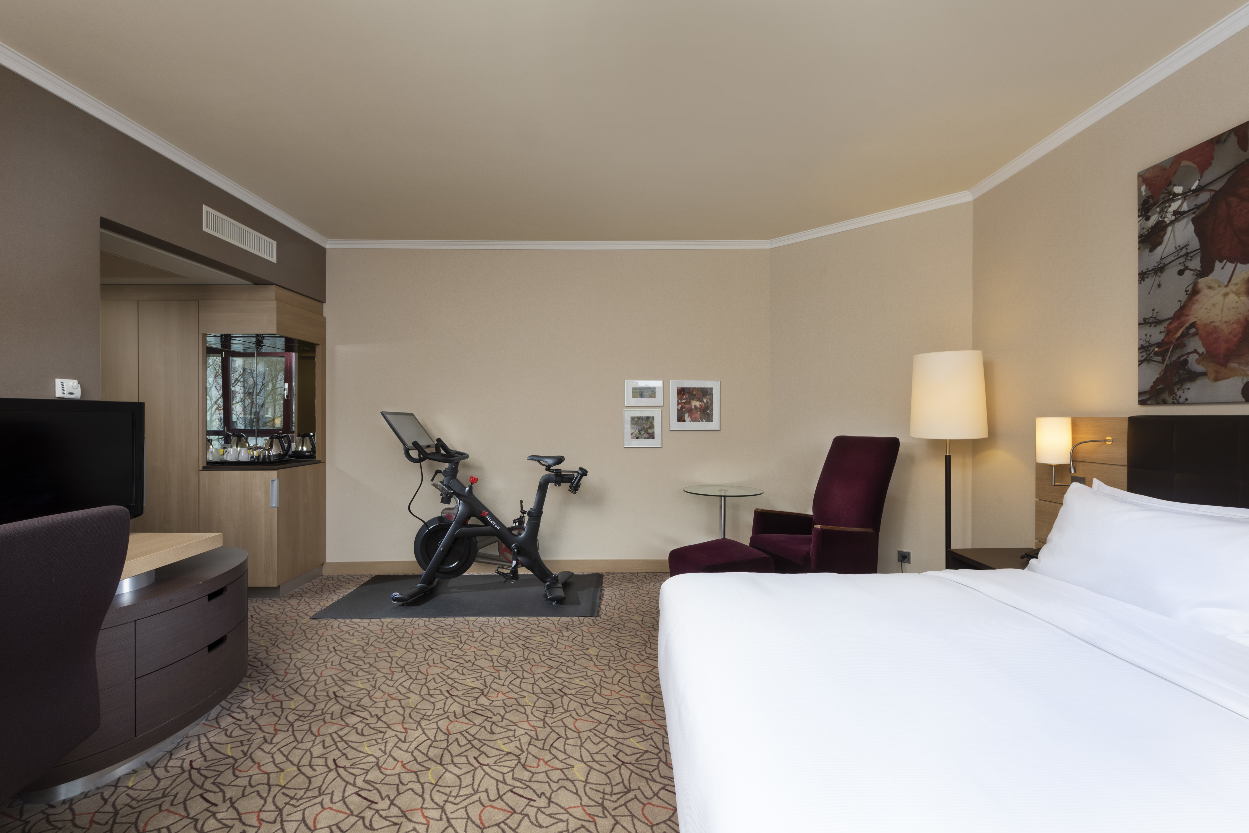 guestroom with king bed and peloton bike