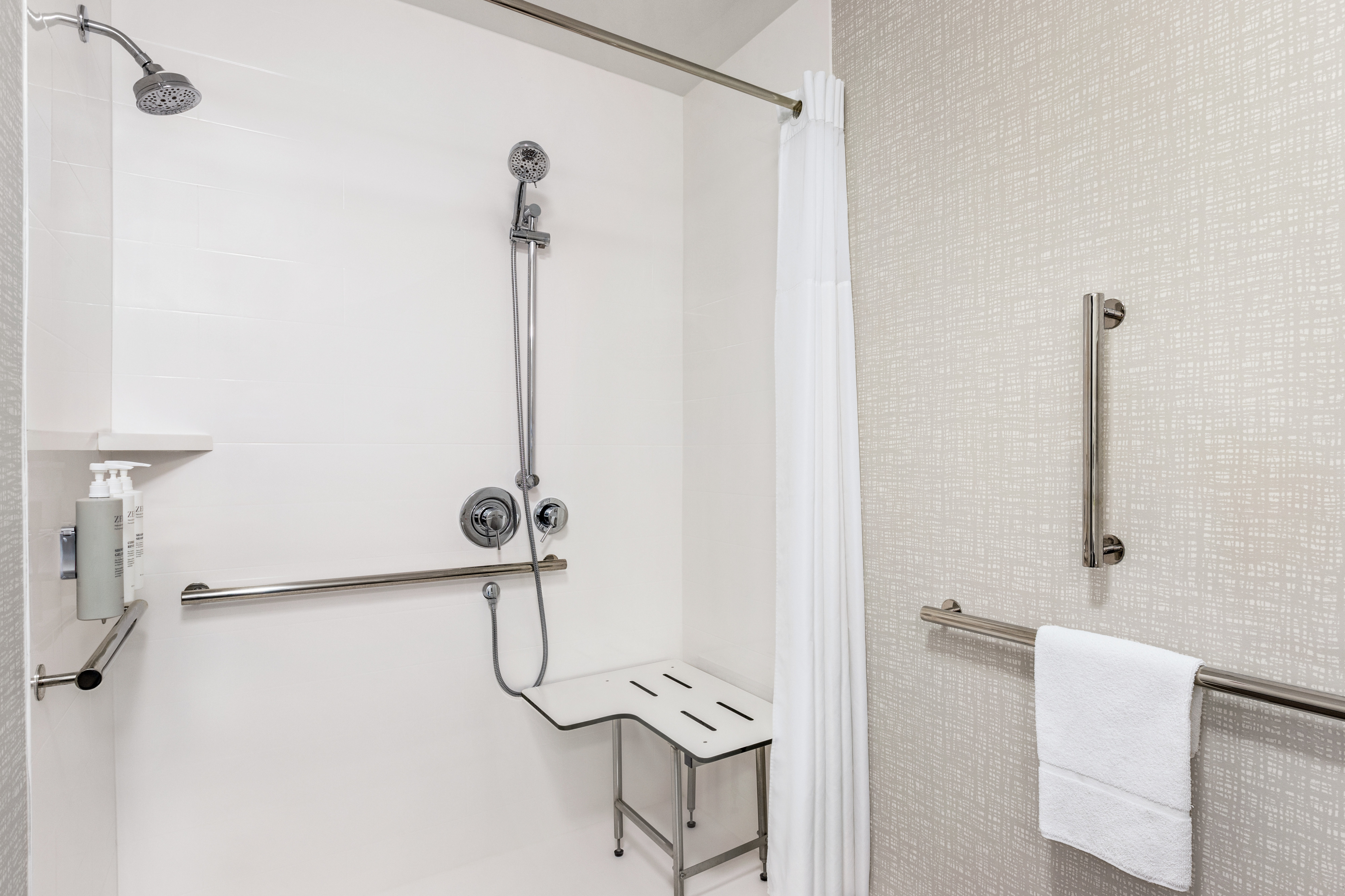 Large and bright guest shower with accessible roll-in features