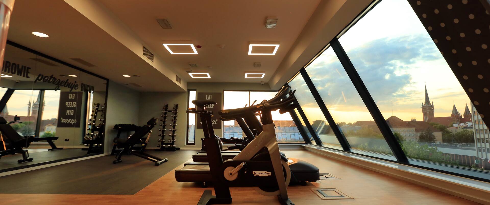 Fitness center with exercise machines and city view